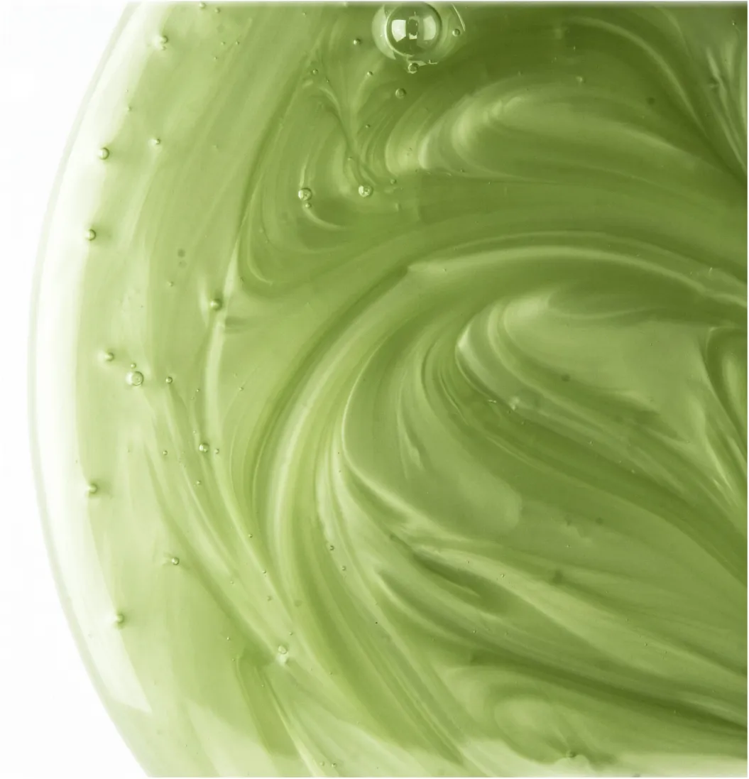 A creamy green shampoo texture.