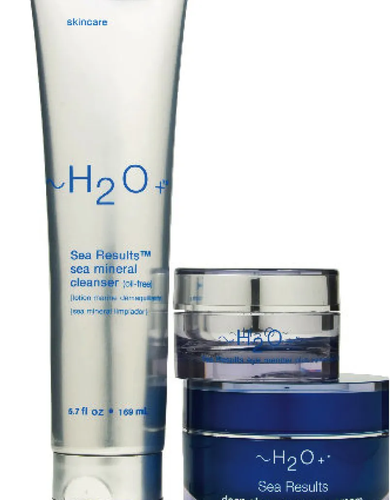 A trio of highly reflective skincare jars and tube.